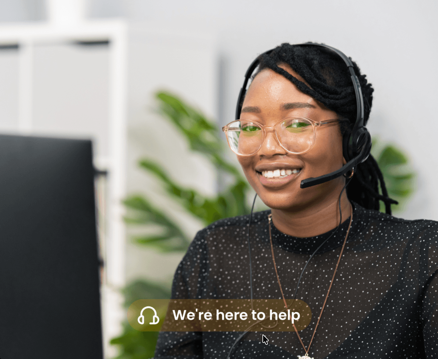 A Splitmulti support agent wearing a headset, with a 'We're here to help' badge
